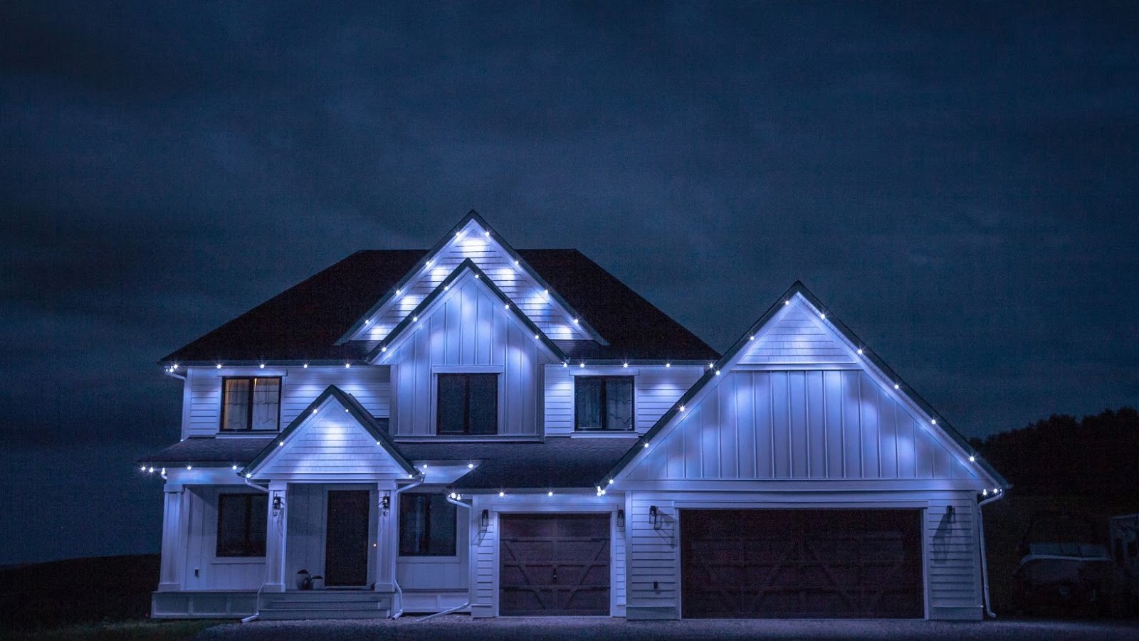 a cozy house with Permanent Christmas Lights with white lights on the roofline