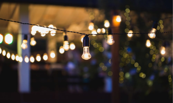 Outdoor bistro and café lighting, also known as bulb lights or café string lights, illuminating an outdoor space