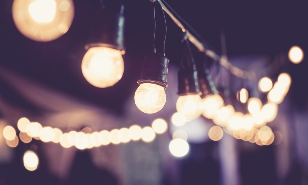 String of warm-toned lights hanging against a dark background.