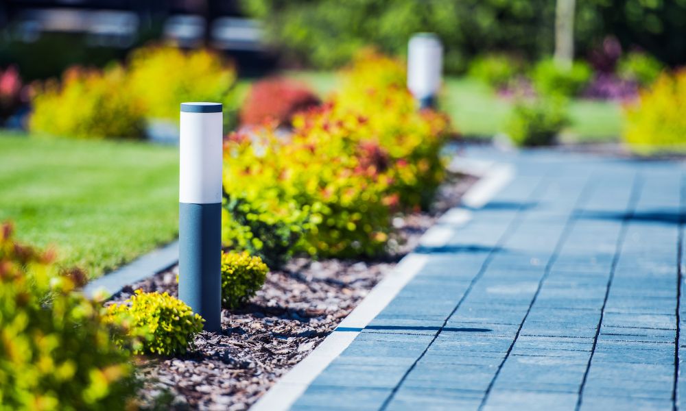 A close-up view of elegant floor lighting embedded in a beautifully designed pathway during the daytime. The lights are seamlessly integrated into the walkway, enhancing both aesthetics and functionality.