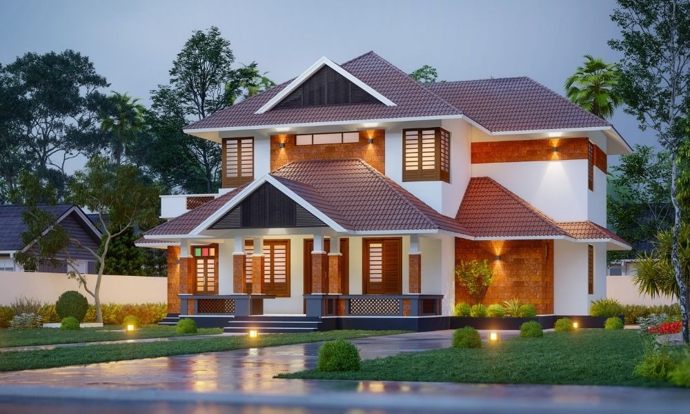 A modern two-story house with a tiled roof, illuminated by warm outdoor lighting.
